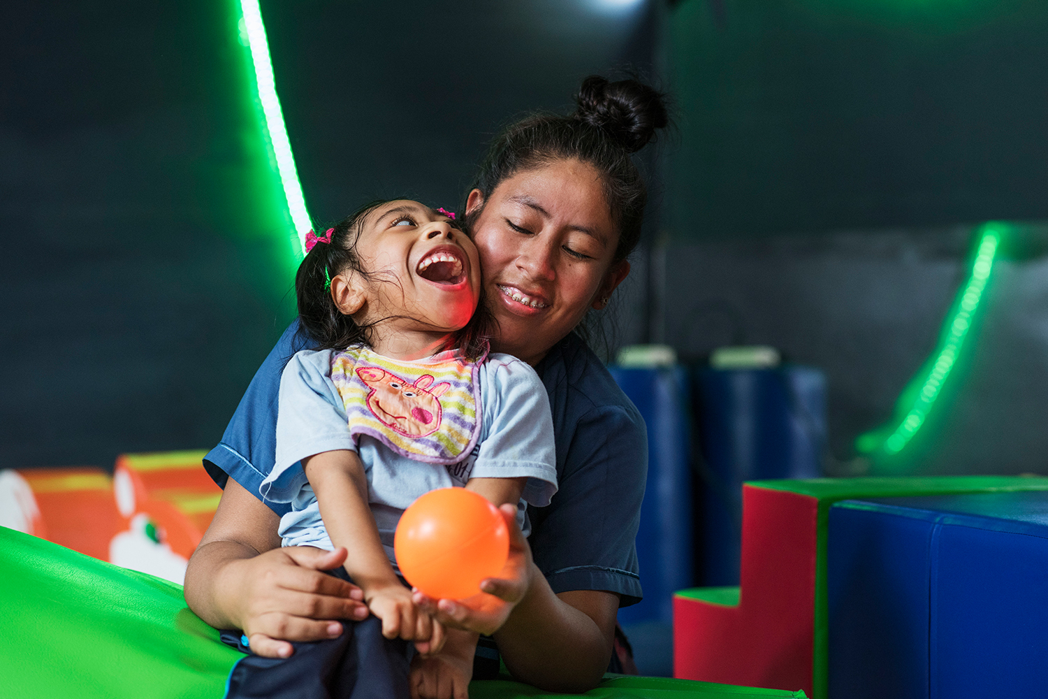 A therapist and child in the sensory stimulation room A therapist and child in the sensory stimulation room