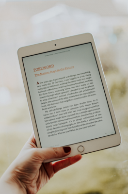 Someone holding an ipad reading a digital book. Someone holding an ipad reading a digital book.