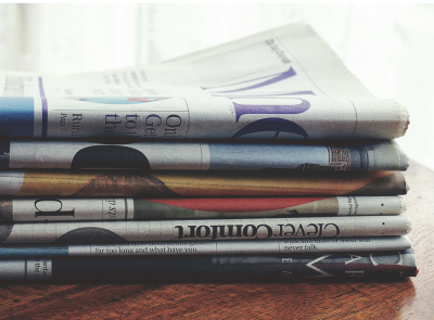 A pile of newspapers on a table A pile of newspapers on a table