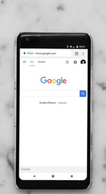 Mobile phone displaying Google website. Mobile phone displaying Google website.